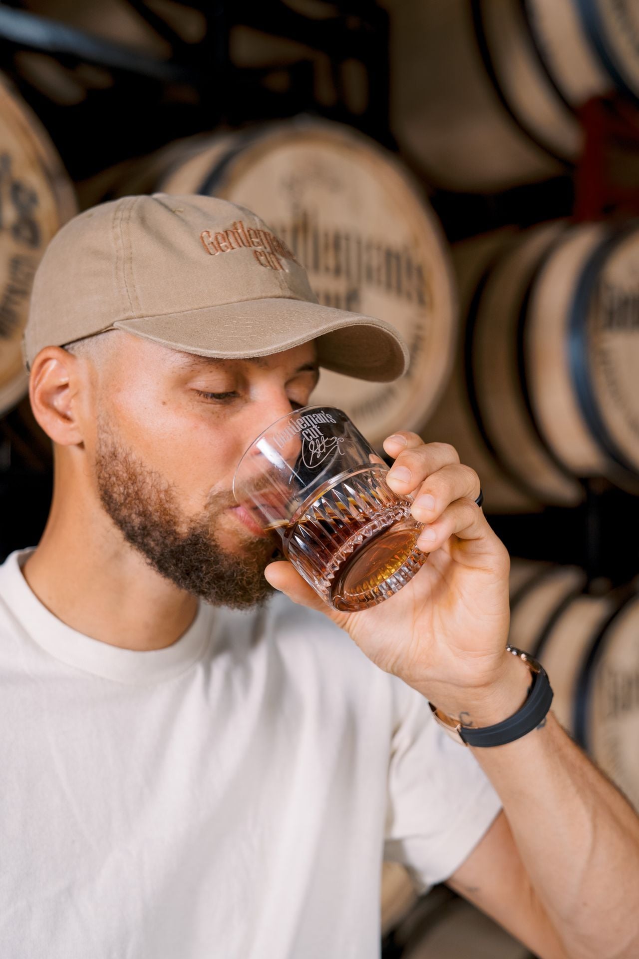 Steph Curry holding a premium bottle of Gentleman's Cut Bourbon